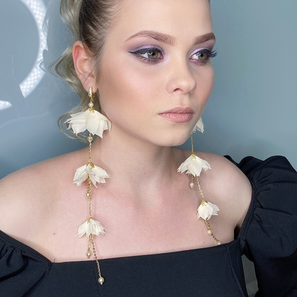 Light long wedding earrings, white earrings, flower earrings, dangling earrings on a girl