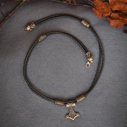 Necklace with Mjolnir Thor Hammer on black leather cord with runes and bear heads. Viking handcrafted Pagan jewelry.