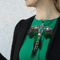 Brooch, Clothing accessory, Body jewelry, Emerald stones, Swarovski crystal, on a jacket