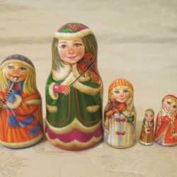 Musical Russian nesting dolls matryoshka - Beautiful winter dressed traditional Russian girls with musical instruments