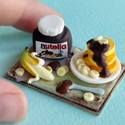 Miniature set of pancakes with chocolate paste on a tray for playing with dolls, dollhouse, scale 1:12