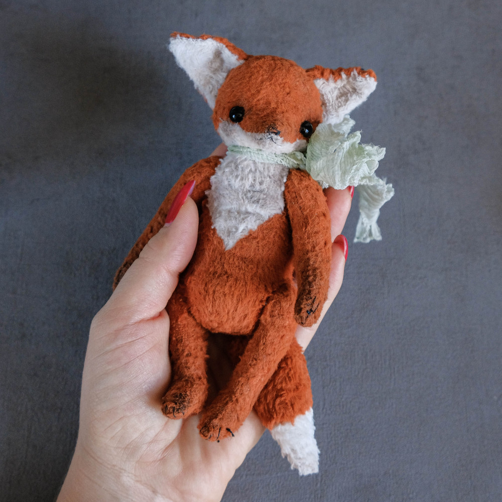 plush toy fox in hand