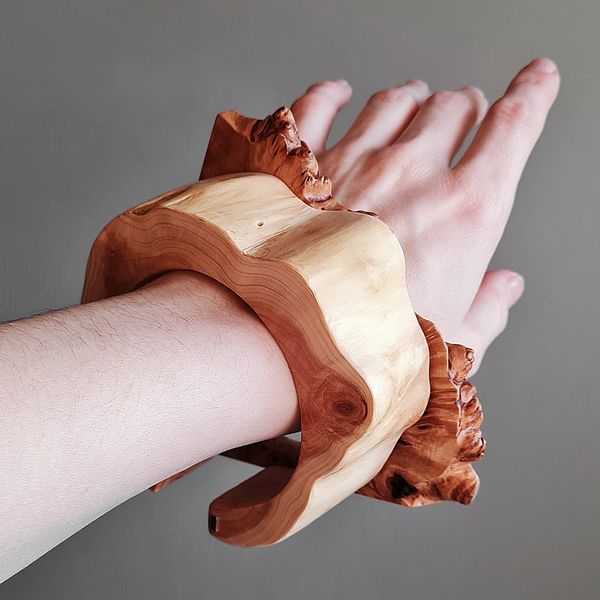 hand, two wooden bracelets