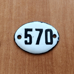 White black oval address number sign 570 apartment plaque vintage