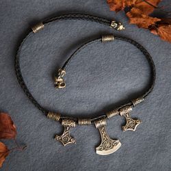 Necklace with Mjolnir Thor Hammer and axe on black leather cord with runes and bear heads. Viking amulet. Pagan jewelry