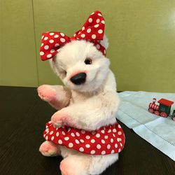Pink teddy bear in a polka dot skirt
