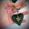 Emerald-beads-on-neck-with-heart-pendant.jpg