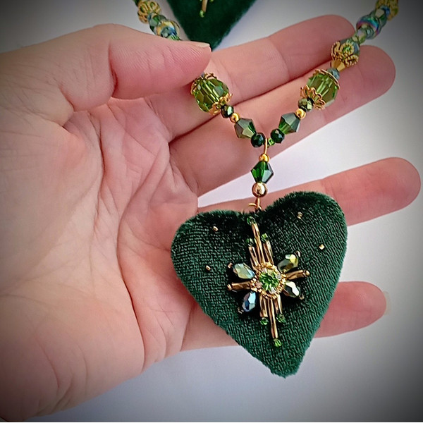 Emerald-beads-on-neck-with-heart-pendant.jpg
