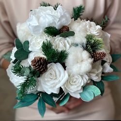 white wedding bouquet. bridal bouquet. pine bridesmaid bouquet. winter wedding bouquet with pine cones.