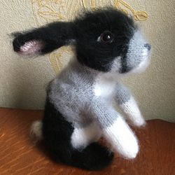 Knitted realistic rabbit. Realistic rabbit toy. Knitted Dutch rabbit.