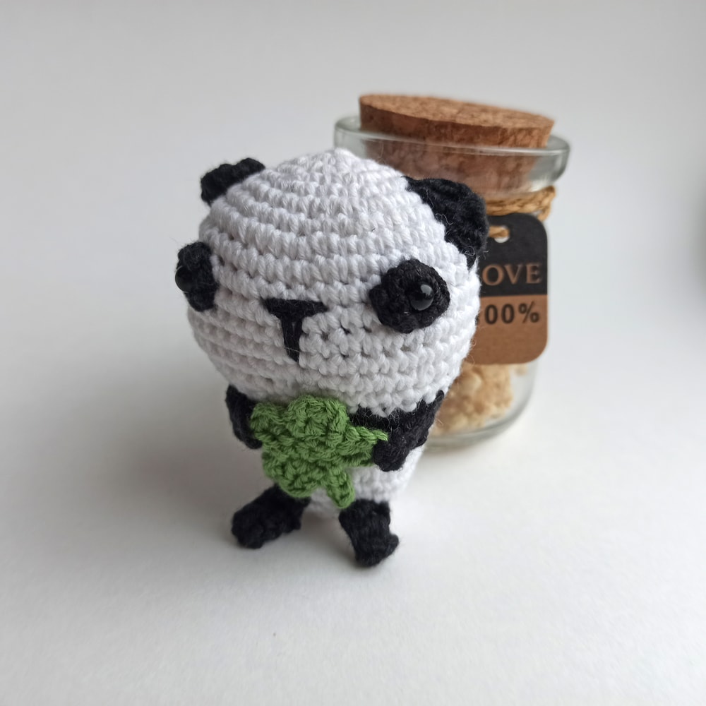 Amigurumi Panda Keychain on the white background below the jar.jpg