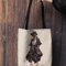 mockup-of-a-woman-s-hand-holding-a-tote-bag-against-a-wooden-background-26693 (2).png