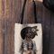 mockup-of-a-woman-s-hand-holding-a-tote-bag-against-a-wooden-background-26693 (7).png