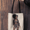 mockup-of-a-woman-s-hand-holding-a-tote-bag-against-a-wooden-background-26693 (17).png