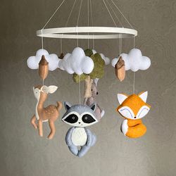 Hanging unisex mobile with a forest animal for a newborn's nursery, the first toy as a gift from a grandmother or godmot