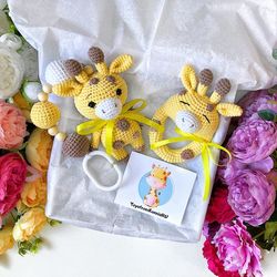 Baby gift box giraffe. Baby rattle, stroller toy