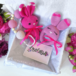 Baby box pink bunny. Baby rattle, stroller toy