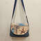 WA9tsCU_4PA.jpg-A small denim handbag with a tapestry flap on a magnetic button and pockets inside and behind