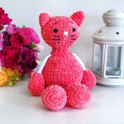 Crochet animal. Plush cat coral colored