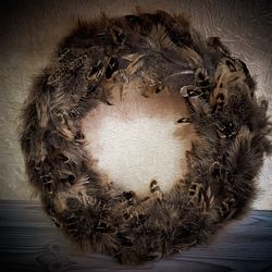 A spring wreath of bird feathers for the Easter decor of the entrance door.Table decoration.