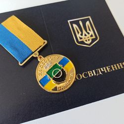 UKRAINIAN AWARD MEDAL "FOR THE DEFENSE OF BAKHMUT" WITH DIPLOMA.  GLORY TO UKRAINE