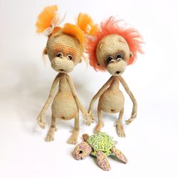 Two stuffed toys orangutans. Amigurumi monkeys, crocheted. Cute baby stuffed monkeys orangutans toys. Gift lovers monkey