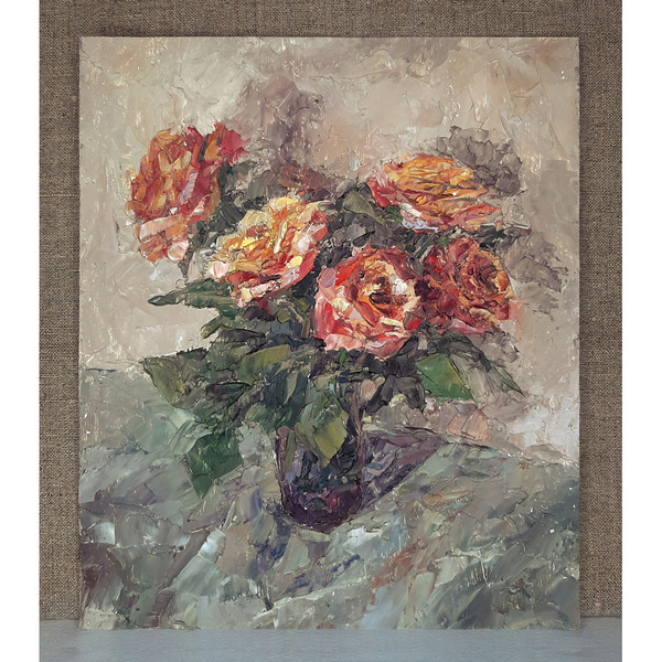 Roses color of fire in a vase on beige background. Flowers art size 11 by 9 inches.
