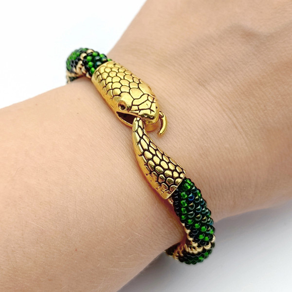 Green snake beaded bracelet on hand