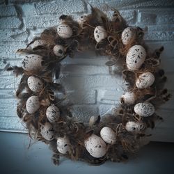 A spring wreath of bird feathers for the Easter decor of the entrance door.Table decoration.