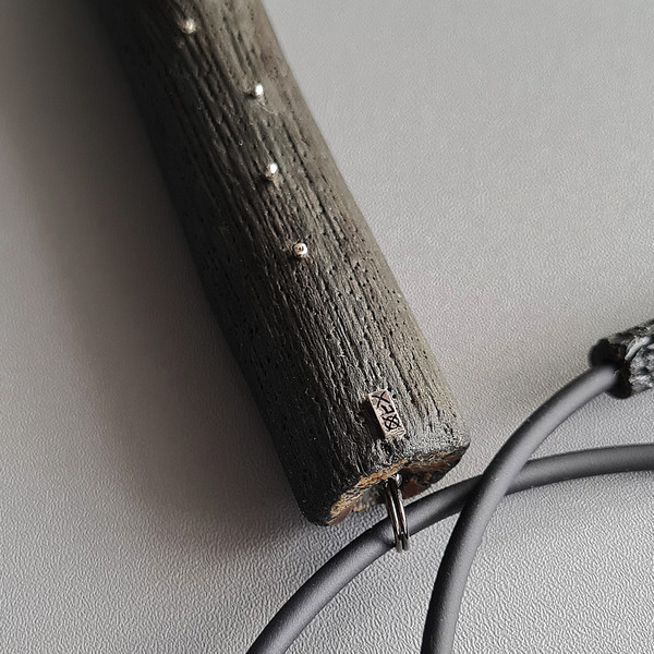 black pendant, wooden pendant, long pendant, rubber cord, silver drops, metal logo