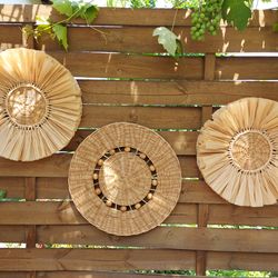 Wicker wall baskets with raffia and wooden deads. Boho decor