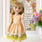 A 14-inch Ruby Red Fashion Friends doll in a beautiful Easter dress with a print of eggs and chickens