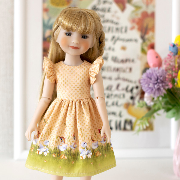 A 14-inch Ruby Red Fashion Friends doll in a beautiful Easter dress with a print of eggs and chickens