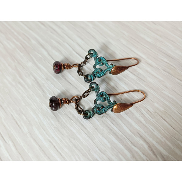 Boho Shabby chic Vintage style solid and natural copper earrings Textured patinated with a garnet bead and chain