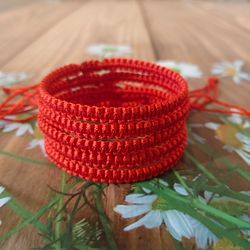 bracelet on the wrist braided with red thread