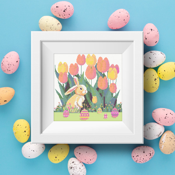 1 Cute Easter bunny in the spring green garden with red yellow pink tulips and multicolored Easter eggs and flowers cross stitch PDF pattern created for Creativ