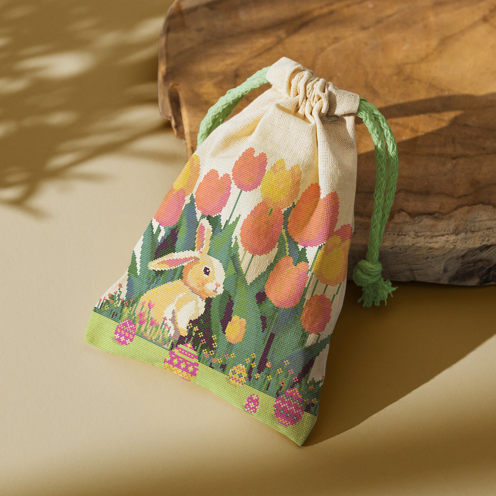 7 Cute Easter bunny in the spring green garden with red yellow pink tulips and multicolored Easter eggs and flowers cross stitch PDF pattern created for Creativ