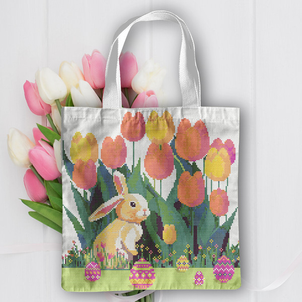 10 Cute Easter bunny in the spring green garden with red yellow pink tulips and multicolored Easter eggs and flowers cross stitch PDF pattern created for Creati