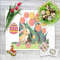 12 Cute Easter bunny in the spring green garden with red yellow pink tulips and multicolored Easter eggs and flowers cross stitch PDF pattern created for Creati