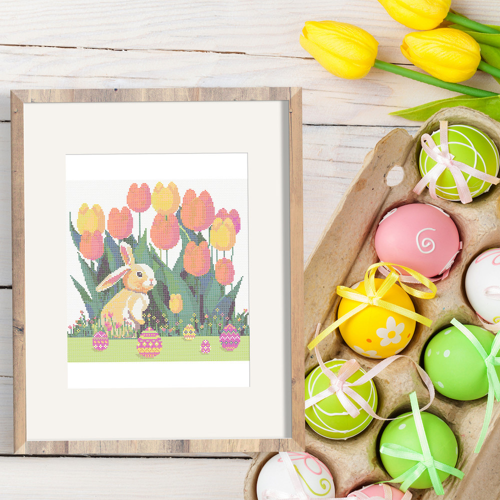17 Cute Easter bunny in the spring green garden with red yellow pink tulips and multicolored Easter eggs and flowers cross stitch PDF pattern created for Creati
