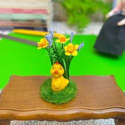 Easter miniature.Chicken on a stand.