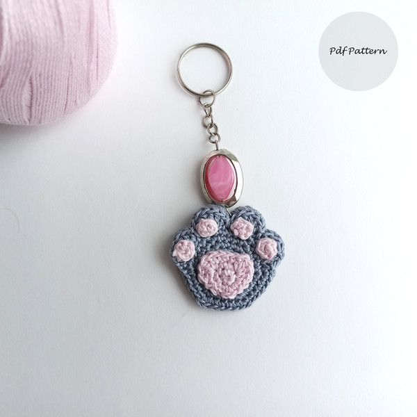Crochet_Cat_Paw_on_a_White_Background_with_a_Pink_Keychain_1.jpg