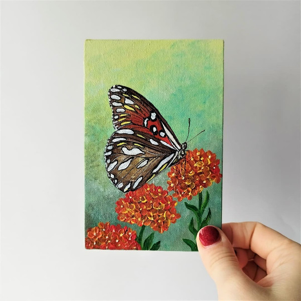 Small-painting-butterfly-and-wildflowers-in-impasto-style-wall-decoration.jpg