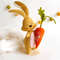 Felt Easter sand color bunny with long ears and bright orange carrot in his hand side view.jpg