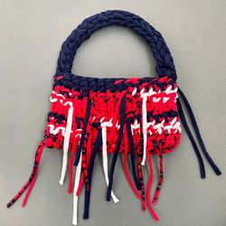 crocheted baguette bag with metal button clasp