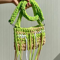 crocheted baguette bag with metal button clasp and long adjustive strap