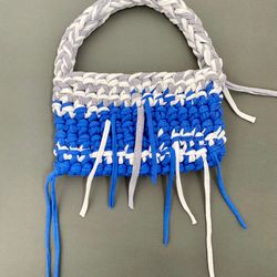 crocheted baguette bag with metal button clasp