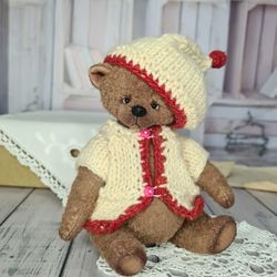 Handmade bear in a hat. Teddy bear in clothes.