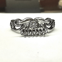 Silver ring "hands" that hold the stone