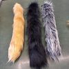 tail made of faux fur for a party, festival, cosplay, masquerade. Gray-black fluffy tail for fancy dress.